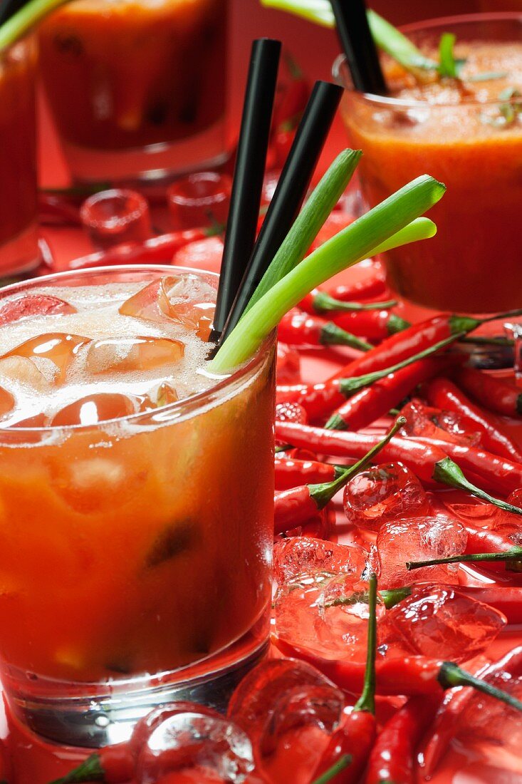 A Bloody Mary, fresh chilli peppers and ice cubes