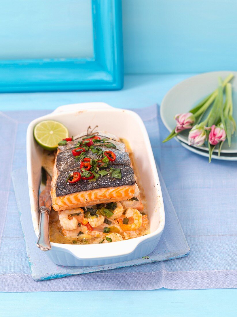 Baked salmon with prawns, chilli peppers and spring onions