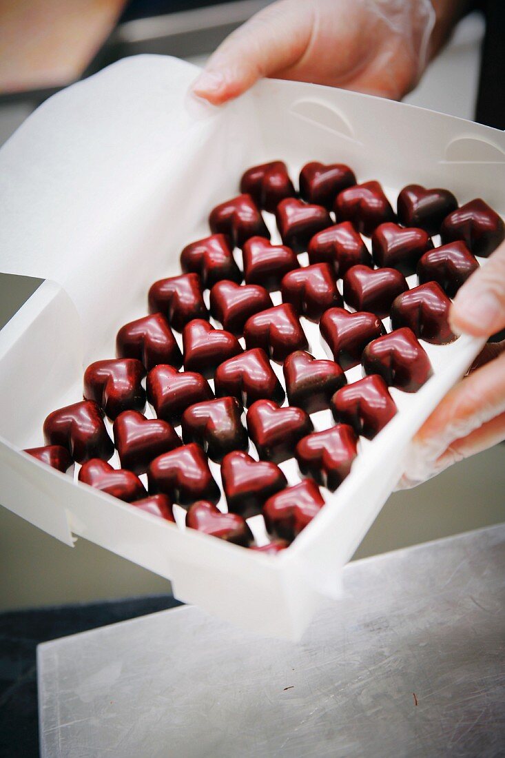 Herzförmige Schokoladenpralinen in einer Schachtel (industriell)