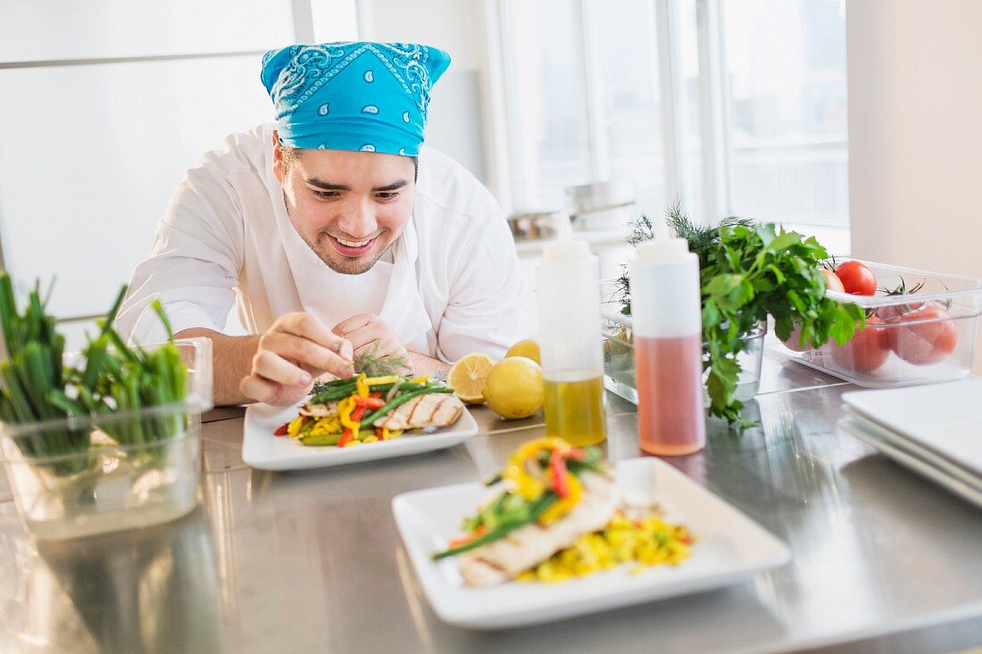 A chef garnishing a dish