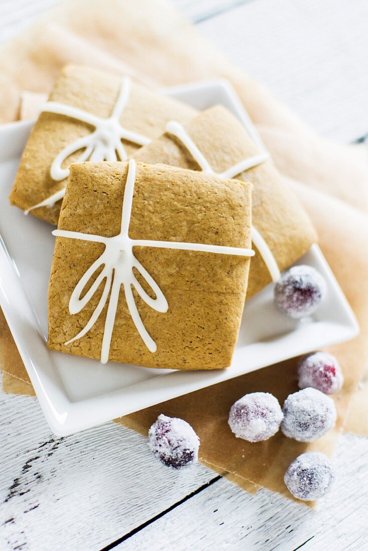Square gingerbread biscuits made with molasses and ginger, decorated with iced bows