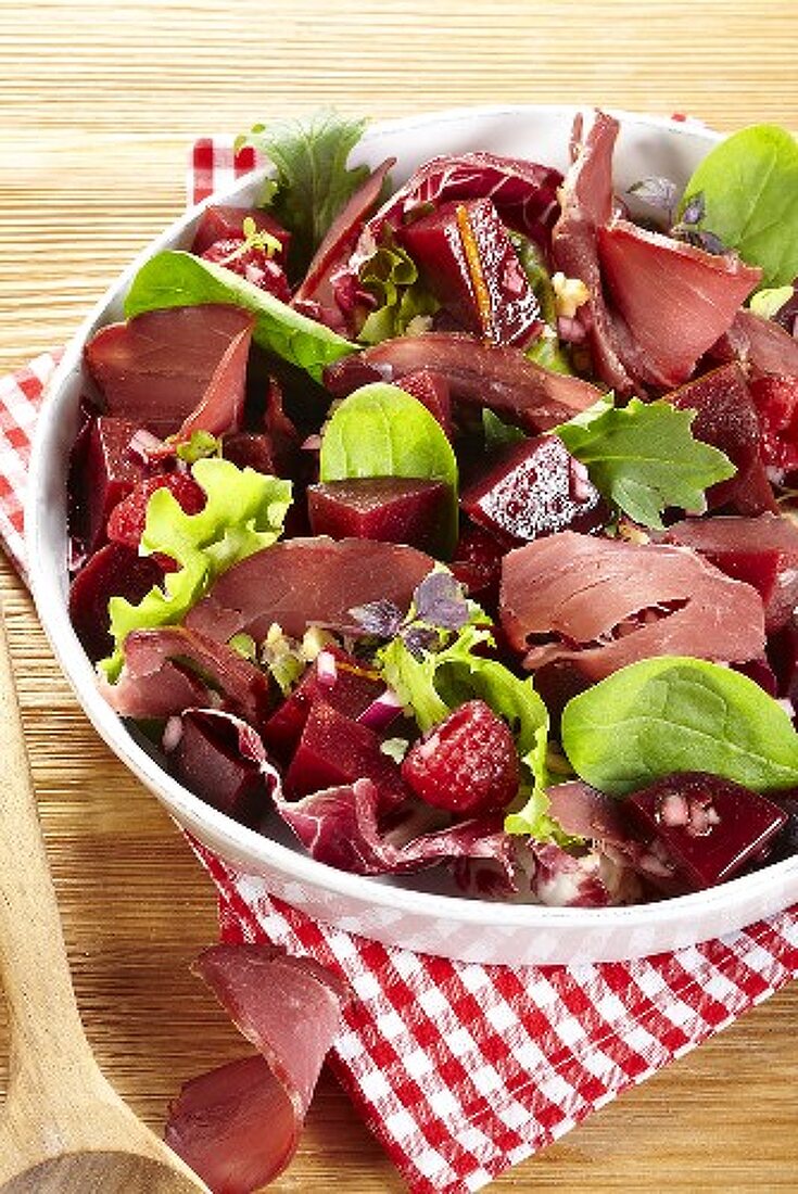Mixed leaf salad with wild boar ham, beetroot and raspberries