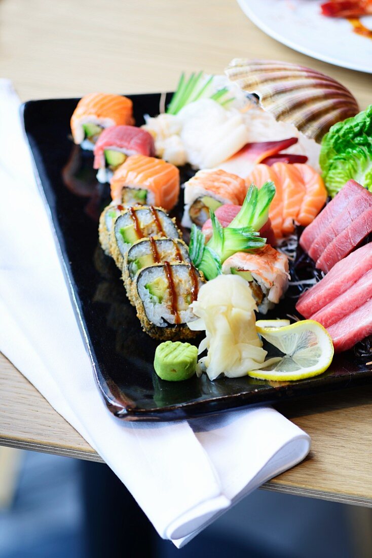 A sushi platter with sashimi in a restaurant