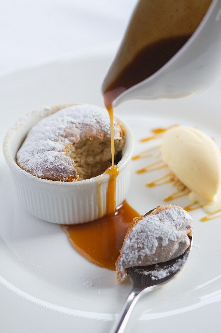 Christmas pudding souffle with caramel sauce and vanilla ice cream