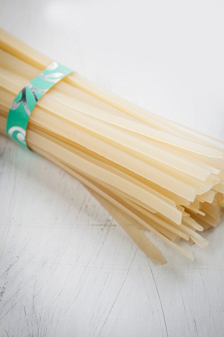 A bundle of flat, Asian rice noodles