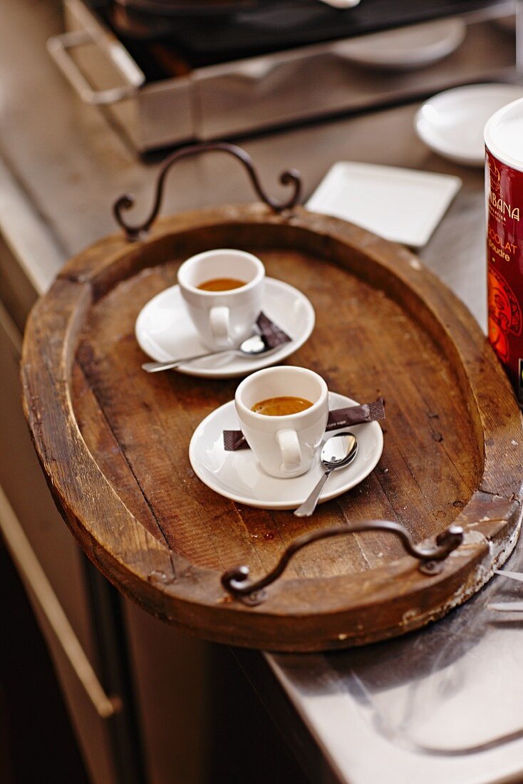 Two espressos on a wooden tray