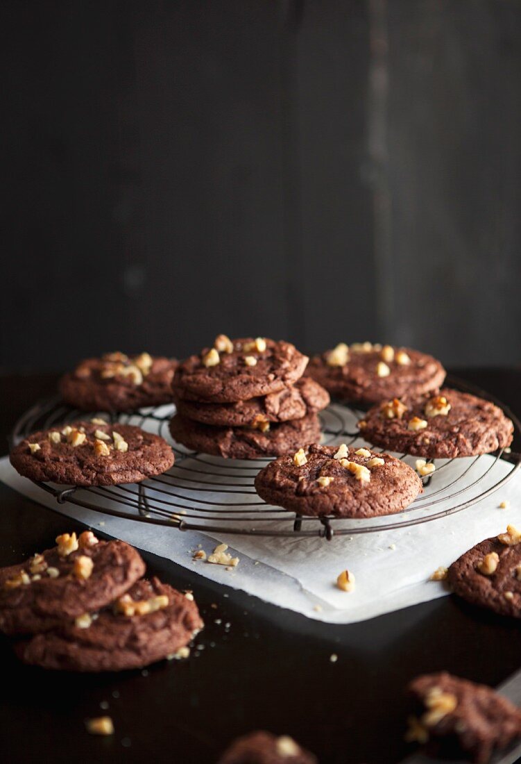Brownie cookies with chopped walnuts on a wire rack