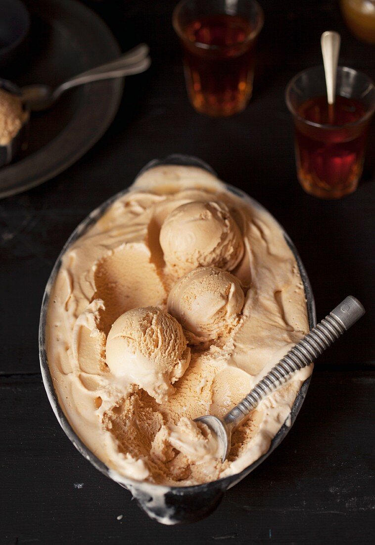 Caramel ice cream with an ice cream scoop