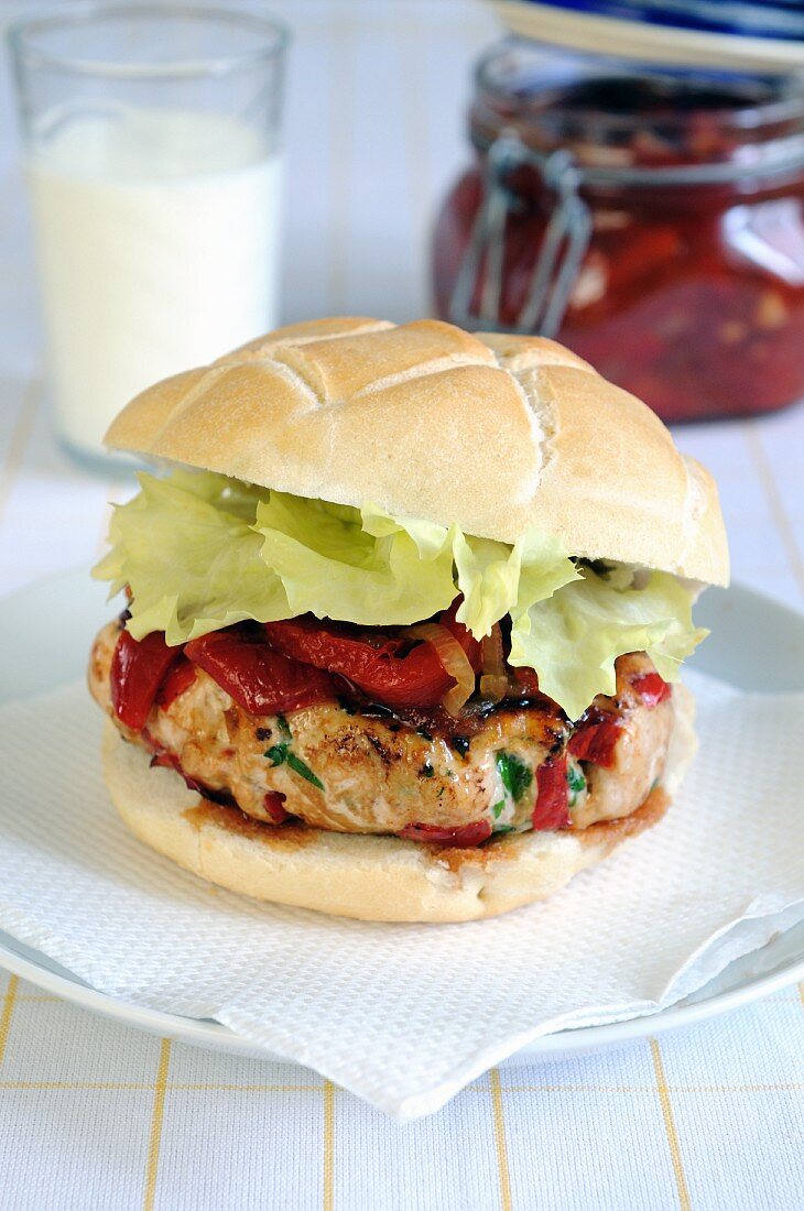 A chicken burger with roasted pepper relish on a ciabatta bun