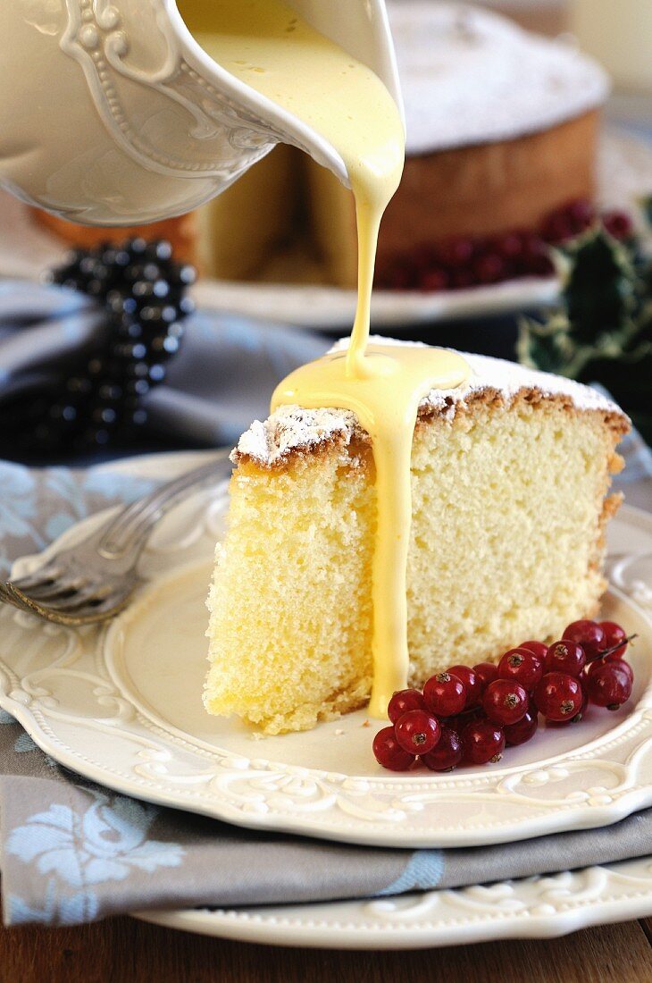 Zabaglione sauce being poured over a slice of Angel Food cake