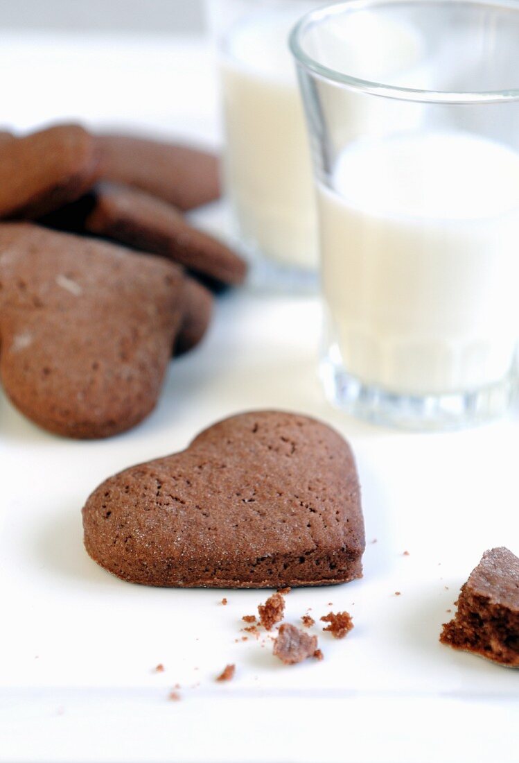 Heart-shaped chocolate biscuits and glasses of milk for Valentine's Day