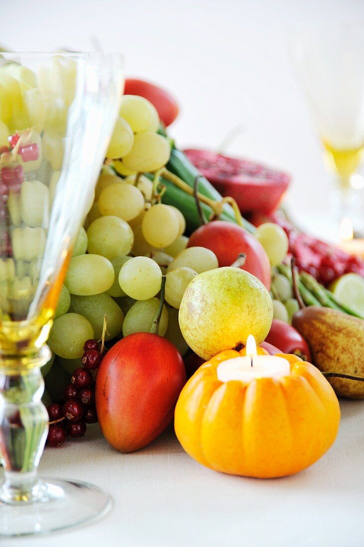 Still-life arrangement of fruit with pumpkin candle