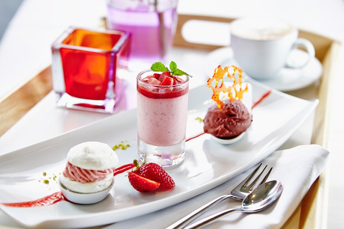 Platte mit verschiedenen Desserts: Erdbeertörtchen, Erdbeer-Joghurt-Creme und Schokoeis