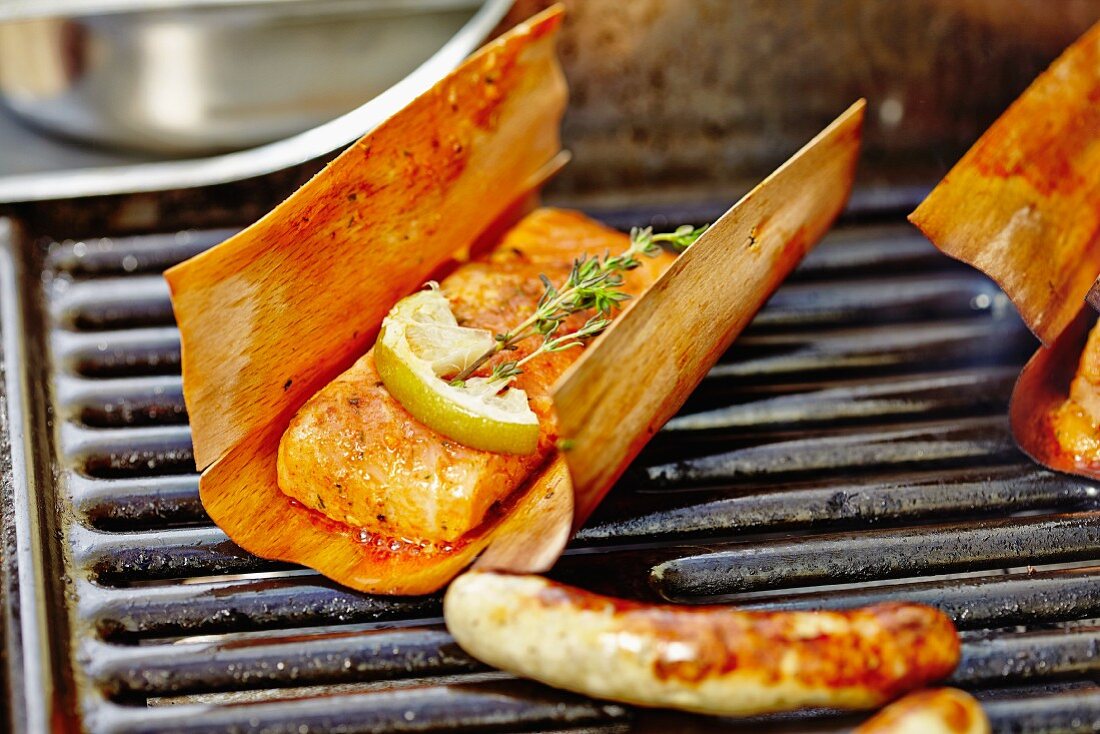 Salmon and sausages on a barbecue