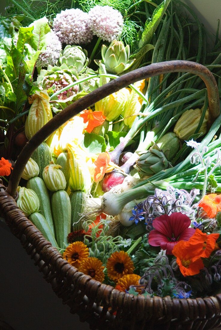 A basket of fresh organic vegetables and flowers