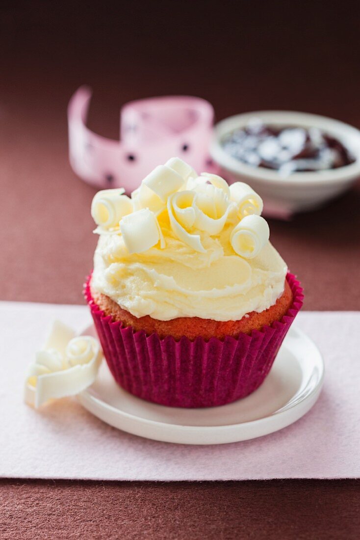 A strawberry cupcake decorated with white chocolate