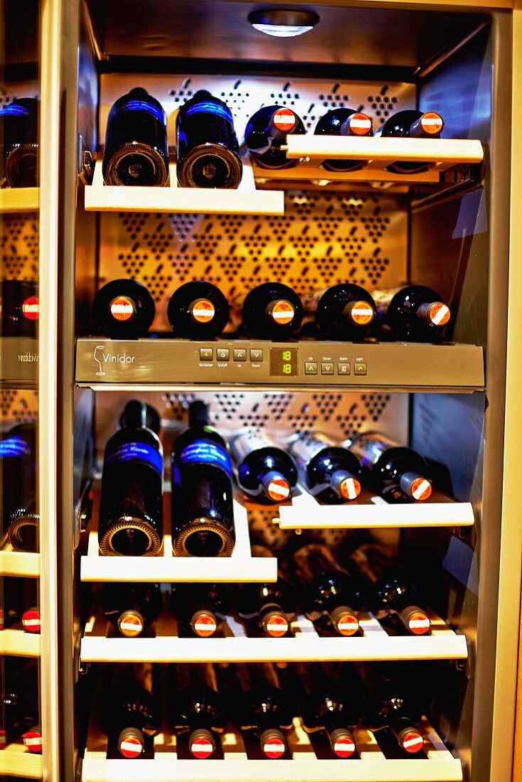 Various bottles of wine in a wine fridge