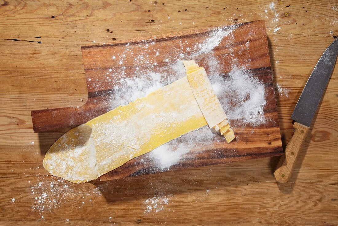 Pasta dough being rolled up