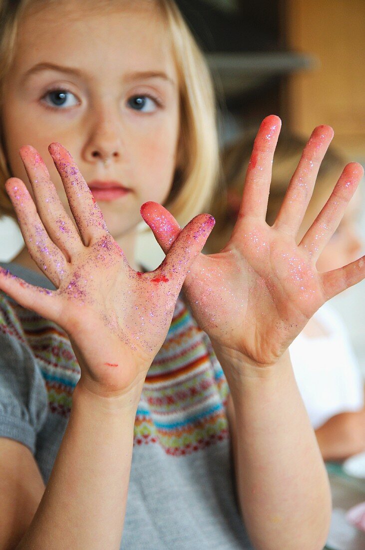 A girl showing smeared hands