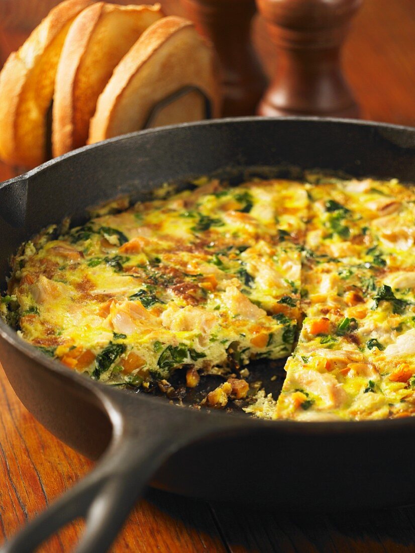 A frittata made with sweet potatoes, salmon and spinach