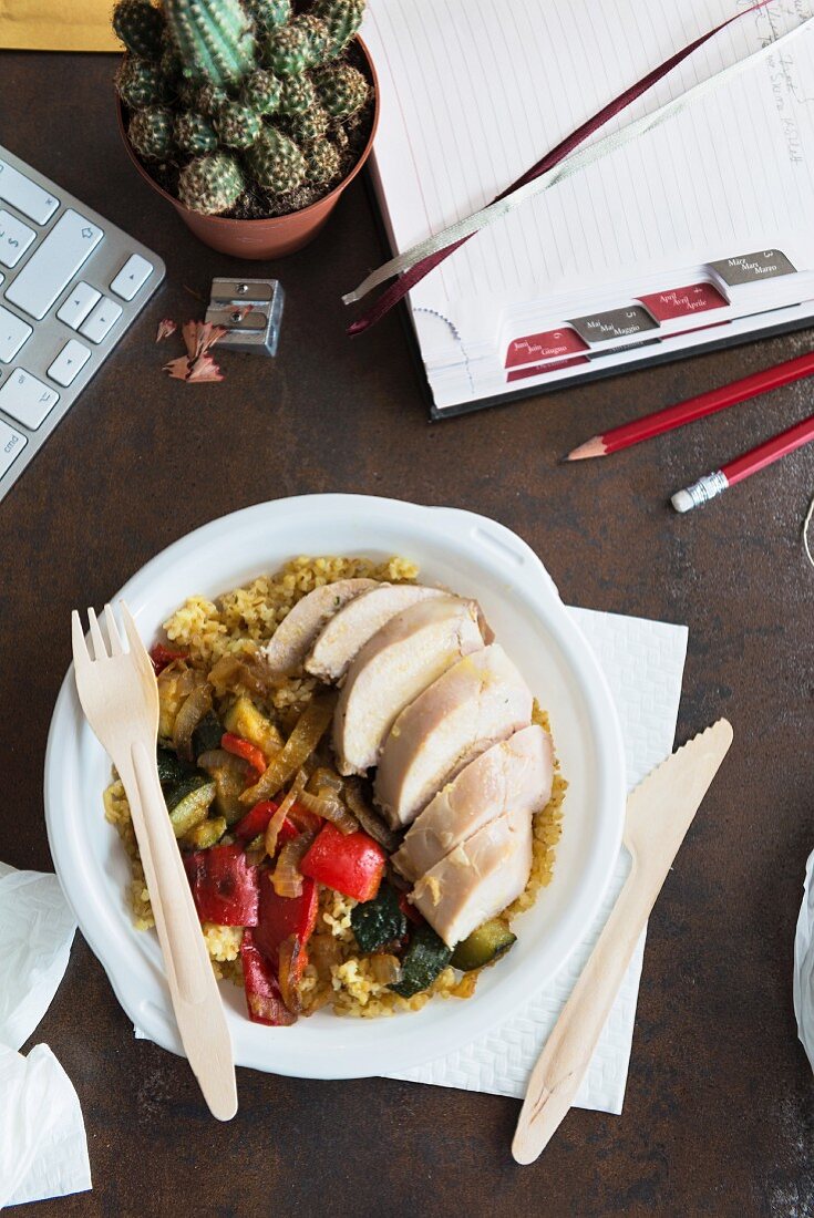Chicken breast with bulgur wheat and vegetables in an office