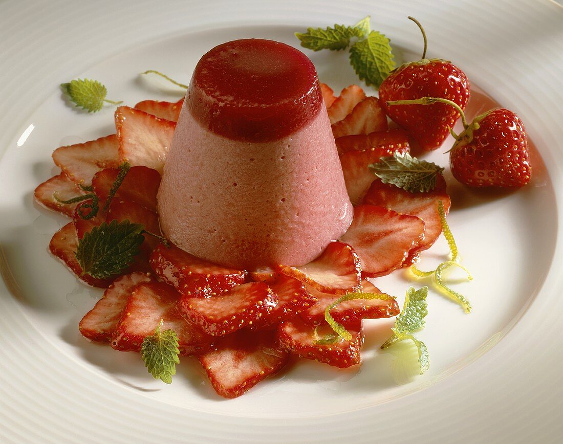 Molded strawberry mousse on fresh strawberries