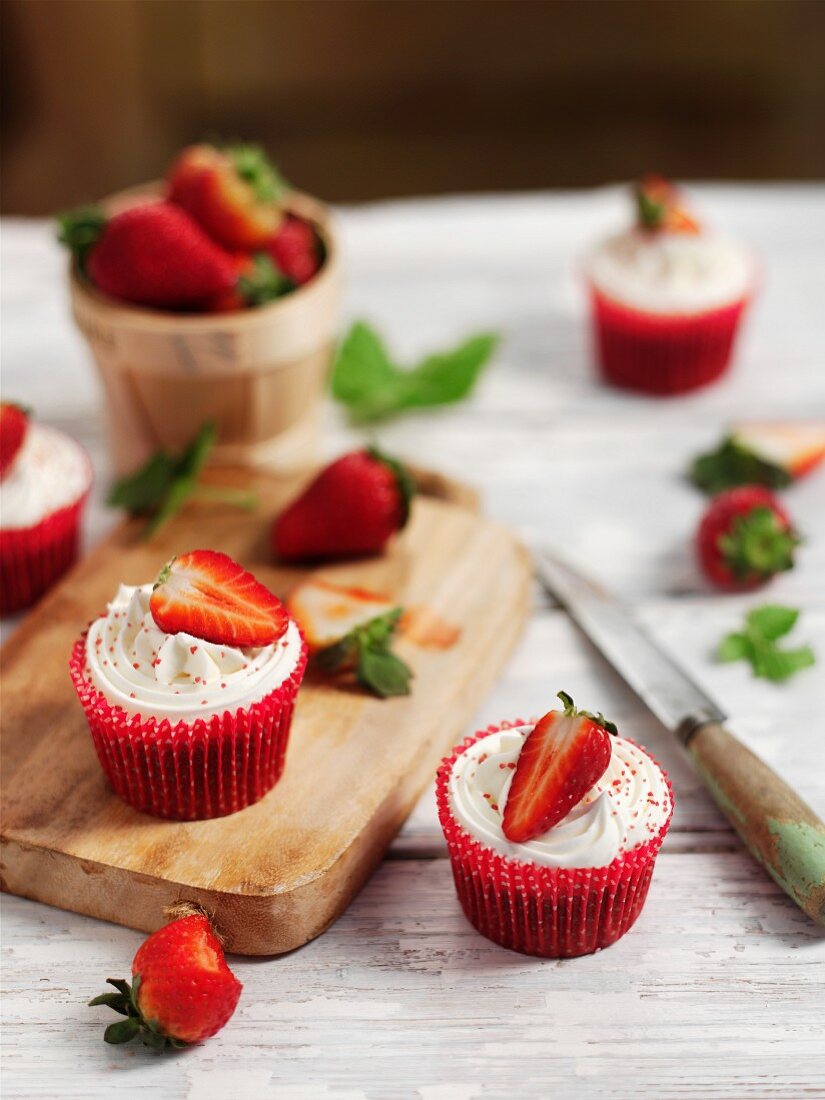 Cupcakes with butter cream and strawberries