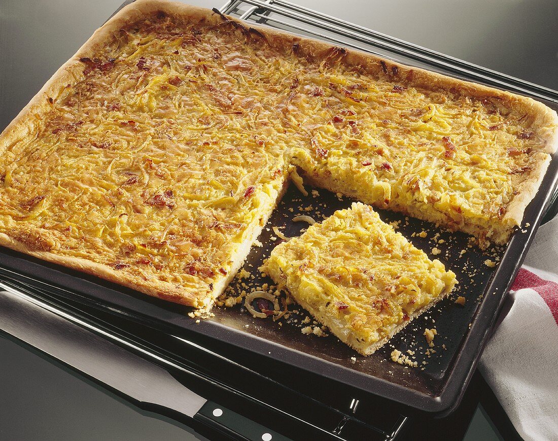 Onion quiche with bacon in roasting tin
