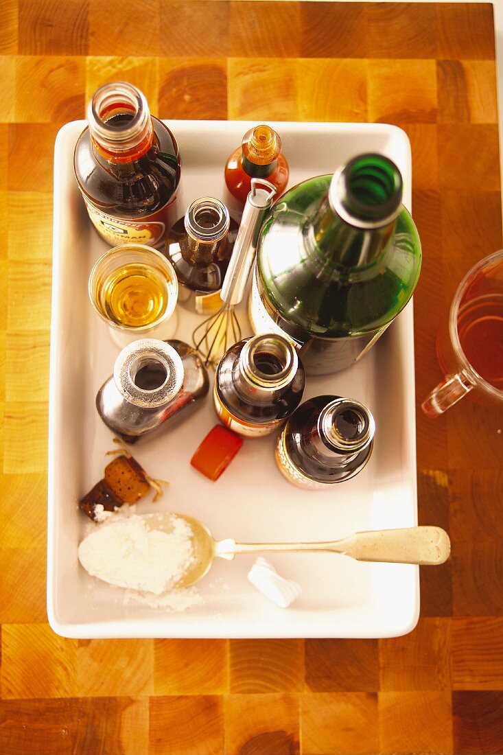 Various spicy sauces and a bottle of wine