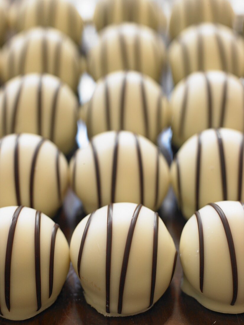 White chocolate pralines with dark chocolate stripes