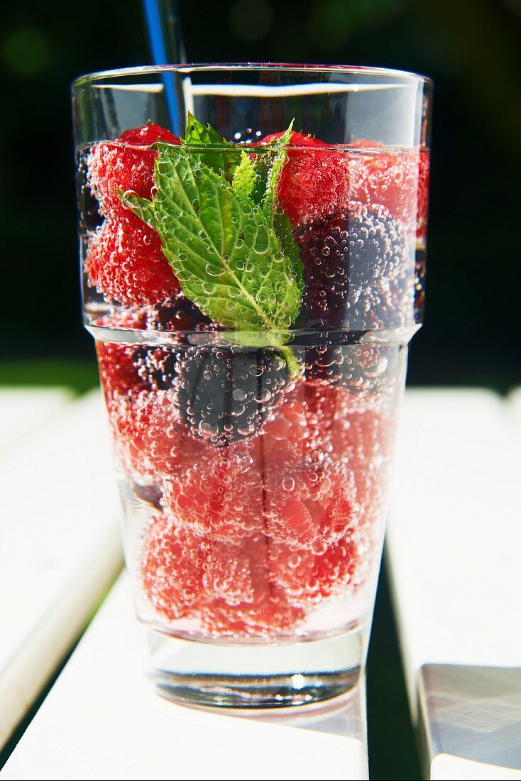 A refreshing drink made with raspberries, blackberries and mint