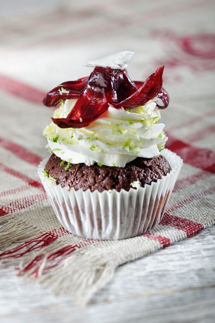 A chocolate cupcake topped with lime cream