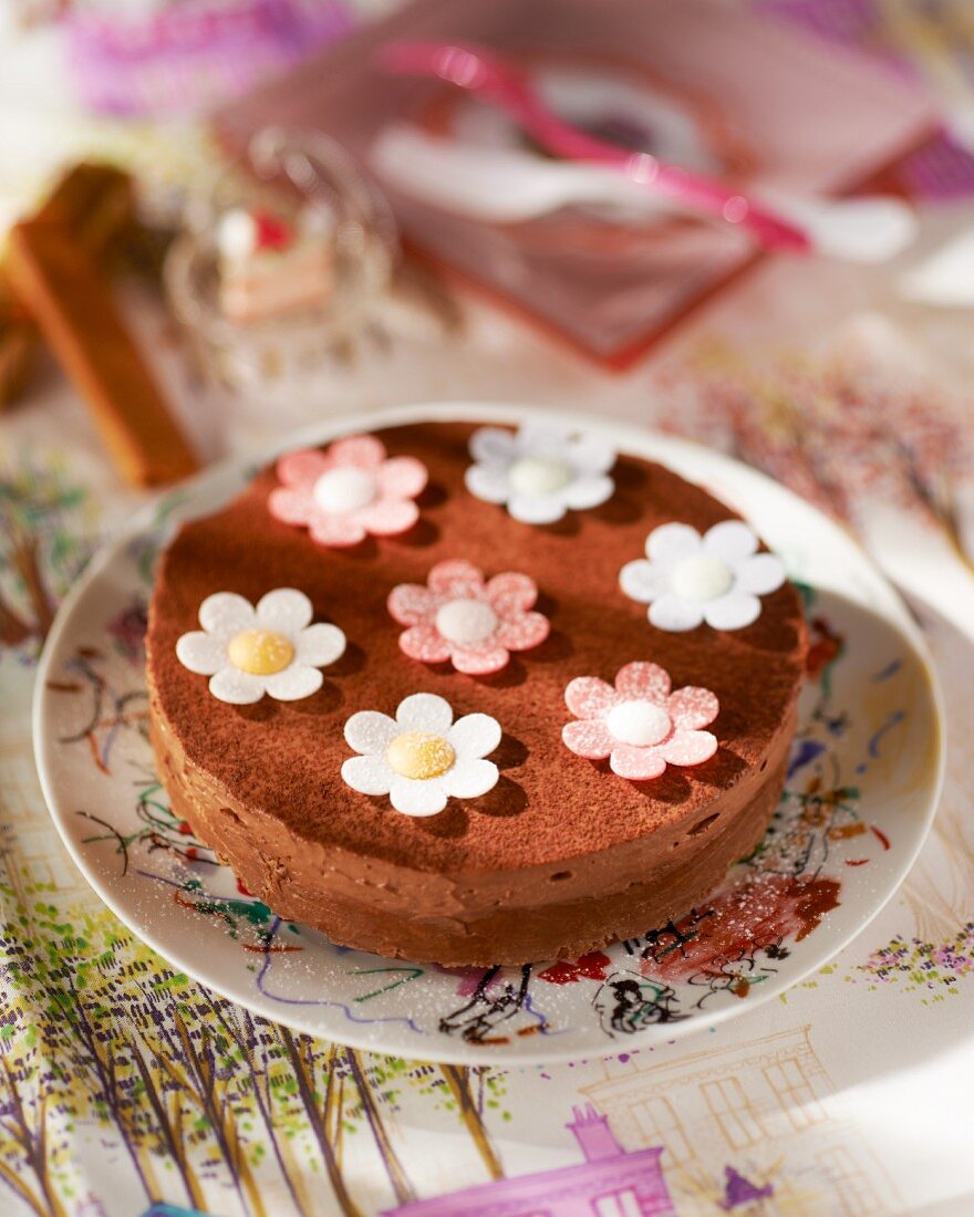 A chocolate cake decorated with fondant flowers