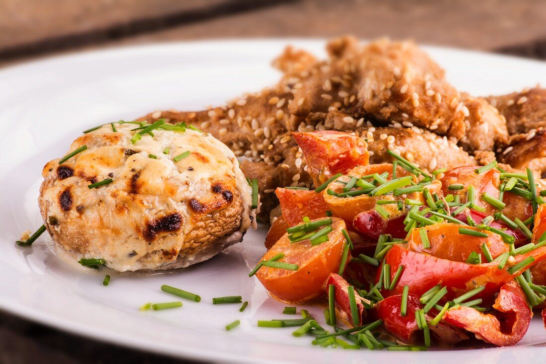 Mushrooms filled with goat's cheese and a tomato and pepper salad