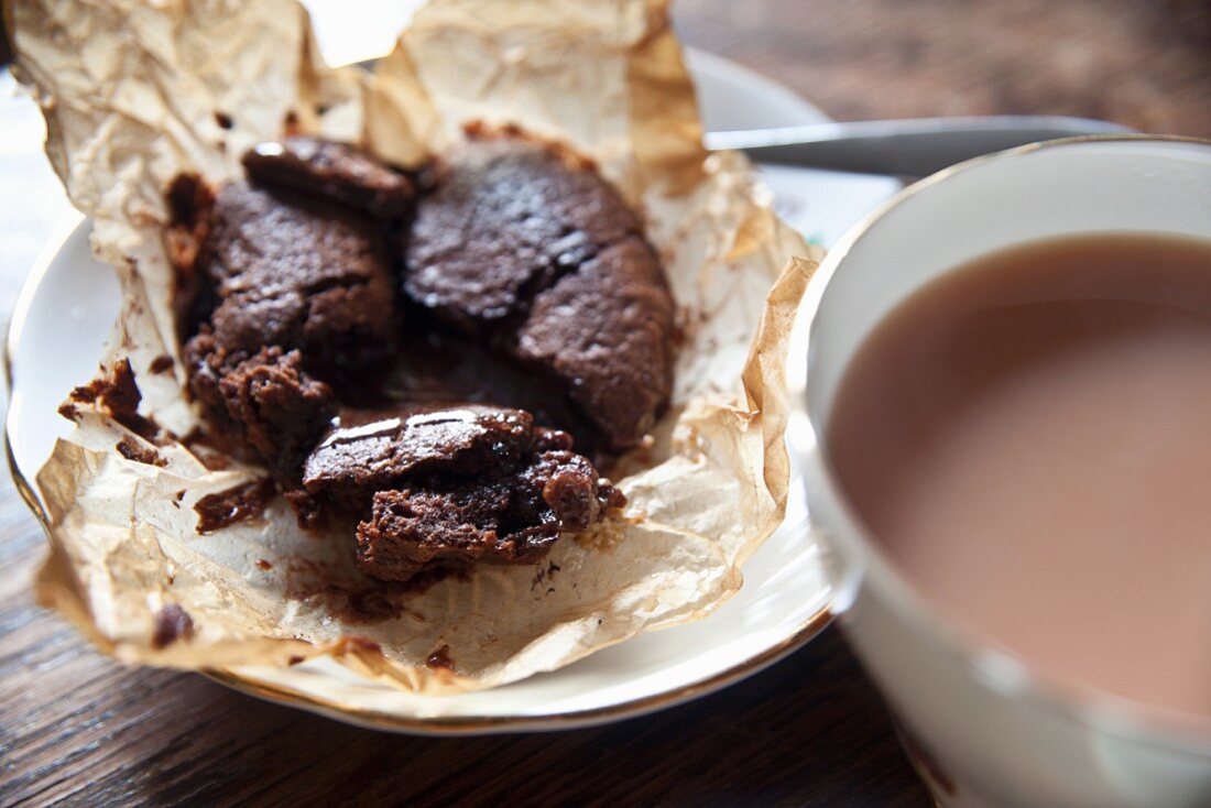 Chocolate cake with a liquid centre served with a cup of tea