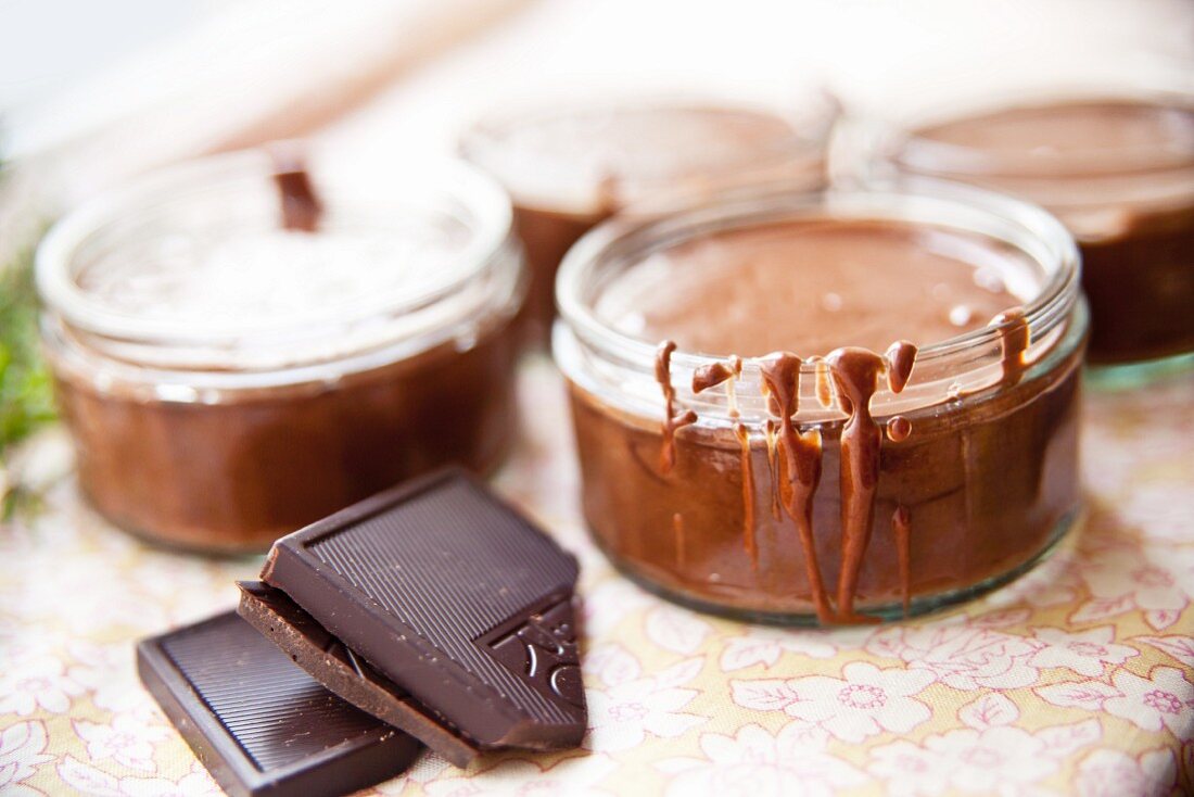 Shallow screw-top jars filled with liquid chocolate