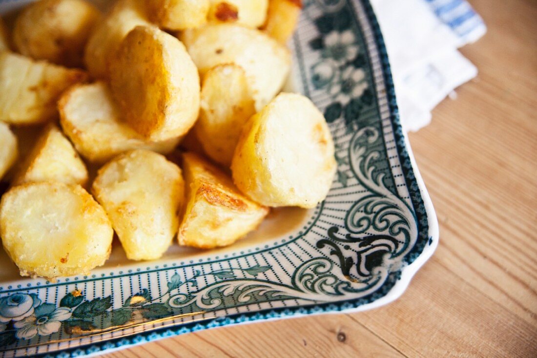 Roast potatoes on a square serving platter