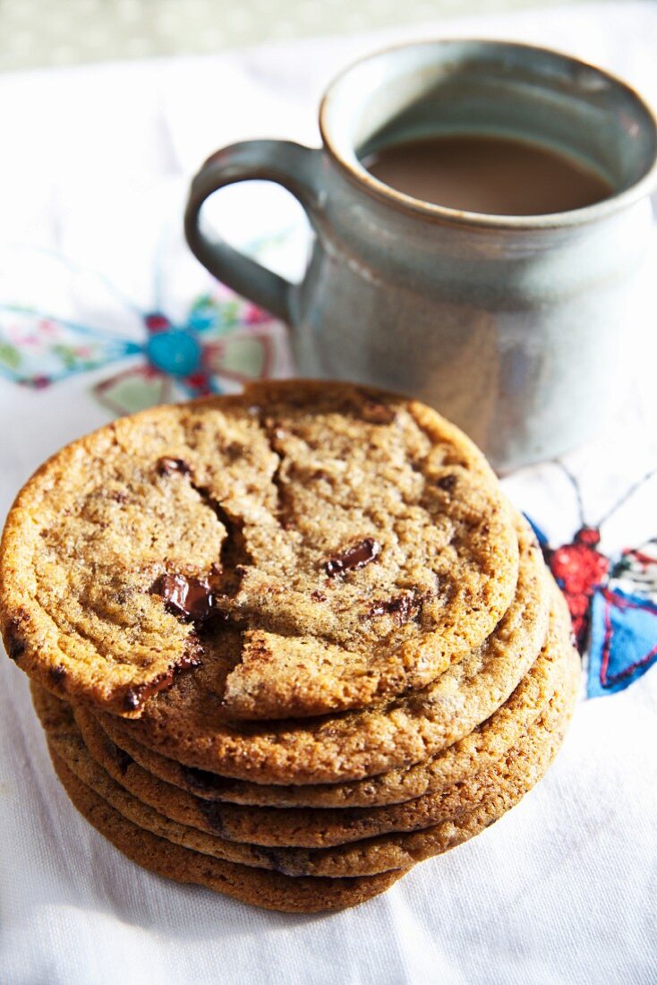 Freshly baked chocolate chip cookies with a mug of coffee