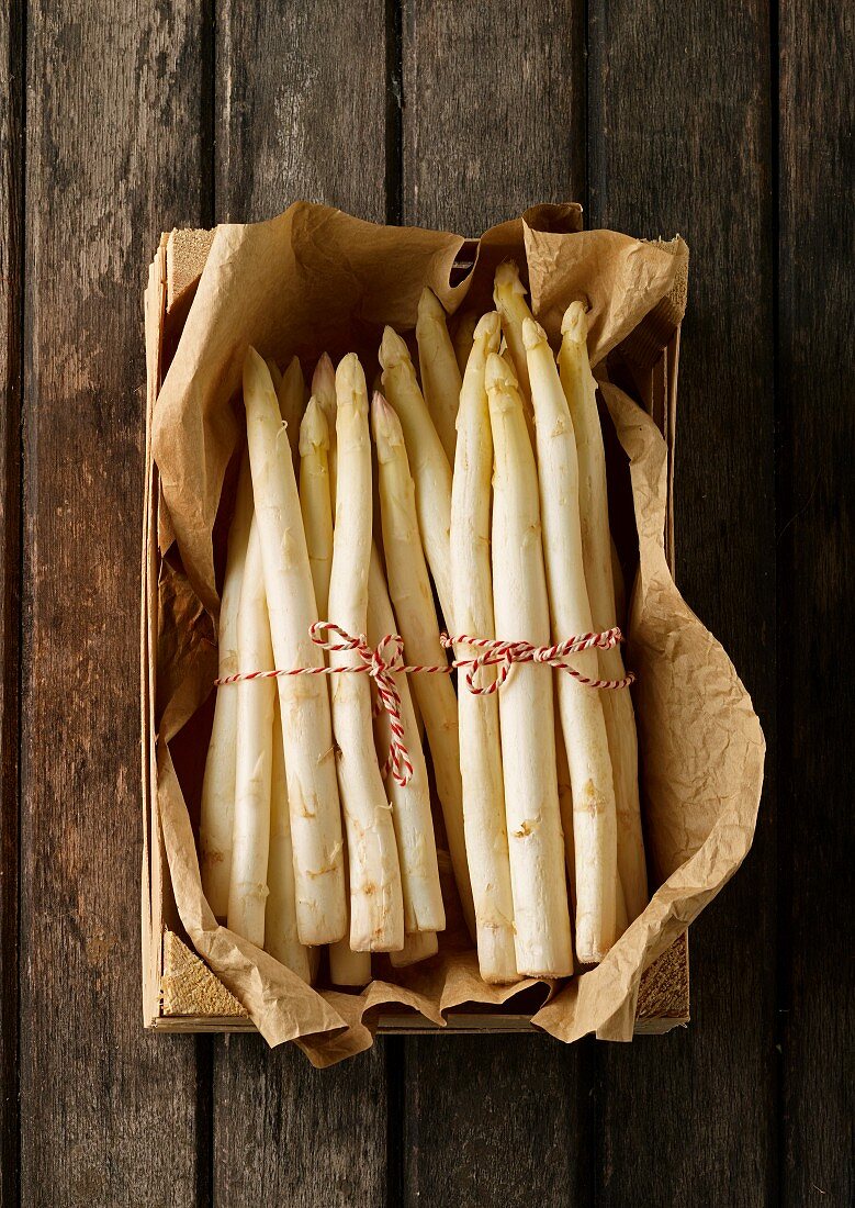 Bunches of fresh white asparagus in a crate