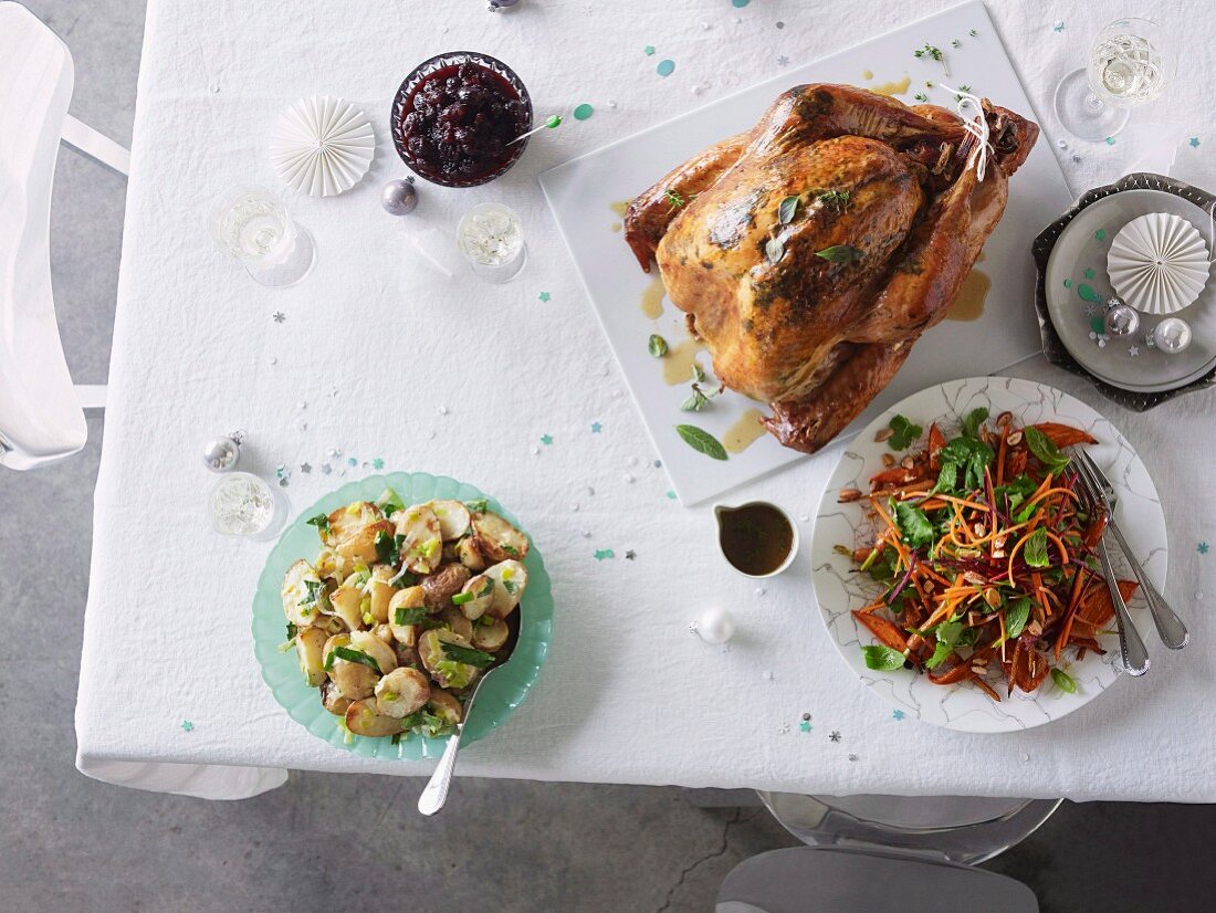 Dry-brined turkey with cranberry relish and verjuice pan juices, Roast potato salad with mustard salad cream and Carrot salad with coriander, parsley, almonds and sherry vinaigrette