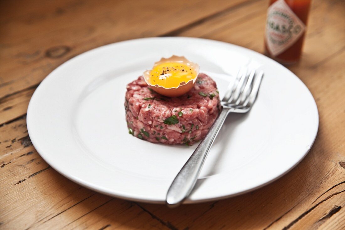 Steak tartare with egg and Tabasco sauce