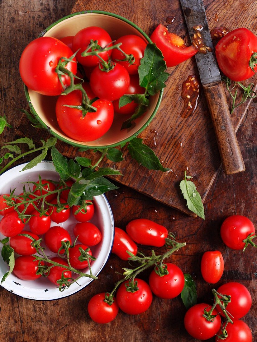 Various ripe tomatoes on a wooden surface