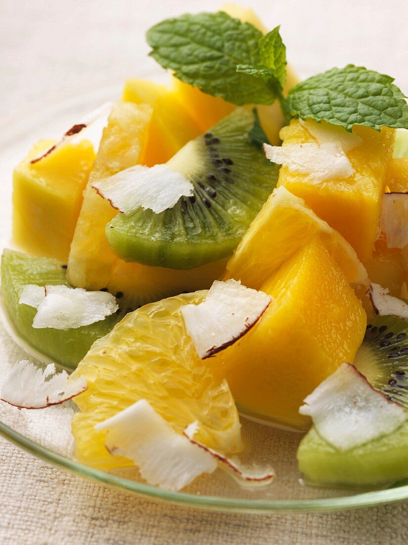 Exotic fruit salad with pineapple, kiwi, mango and coconut