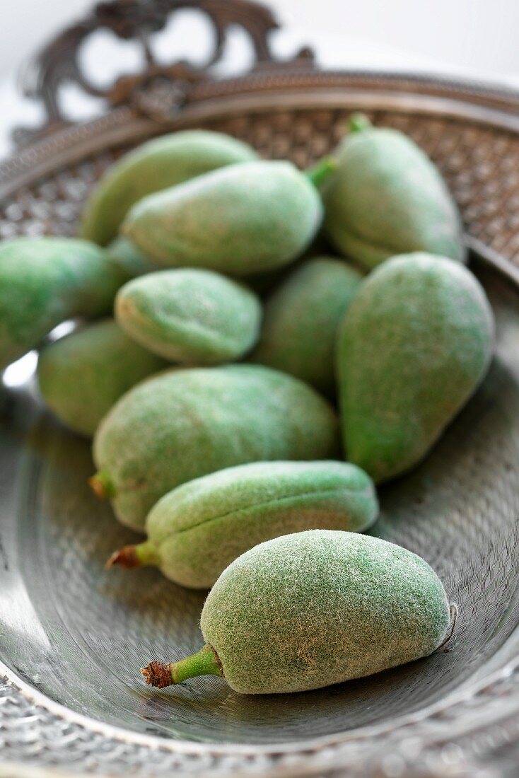Green almonds in a silver dish