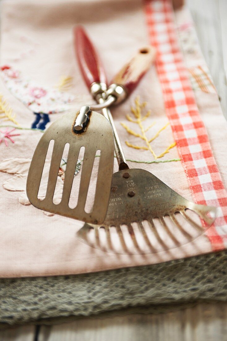 Two spatulas on a country-style tea towel