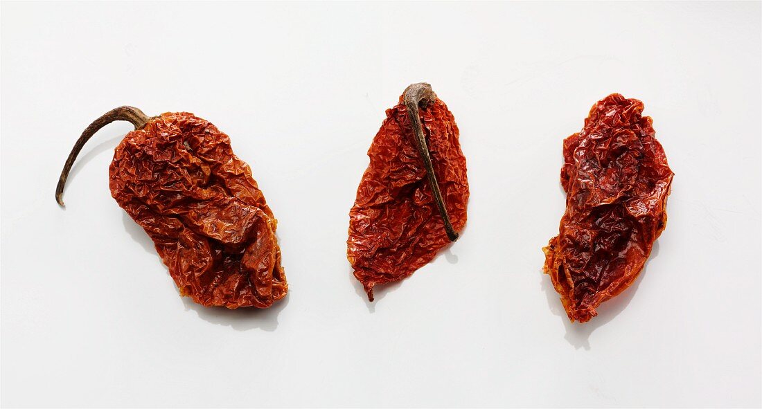 Three dried naga jolokia chilli peppers