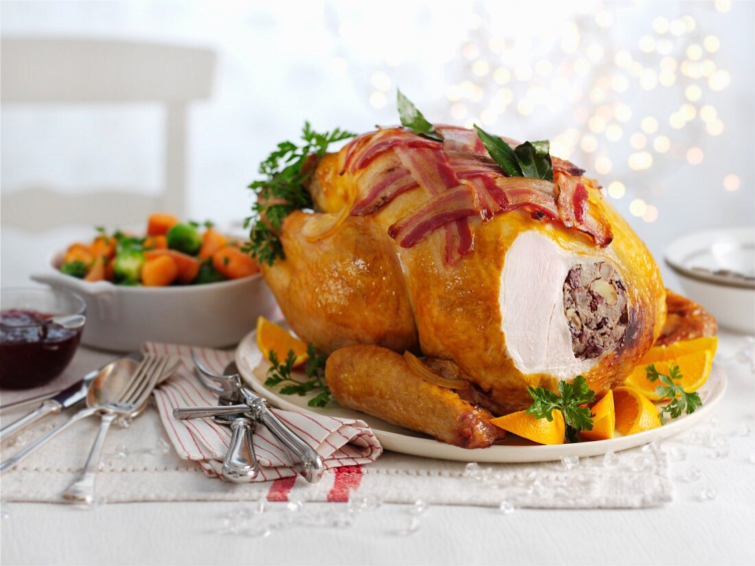 Roast turkey with bacon and oranges (carved) for Christmas