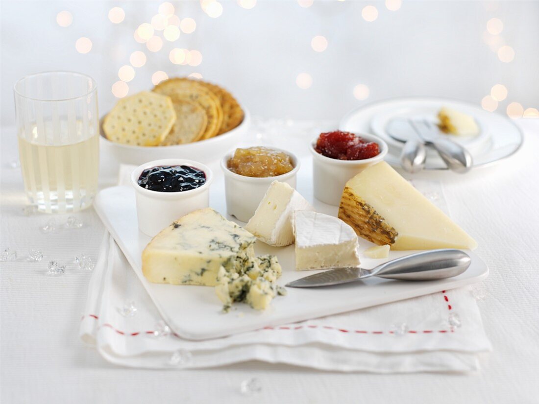 A cheese platter with crackers and various jams for Christmas