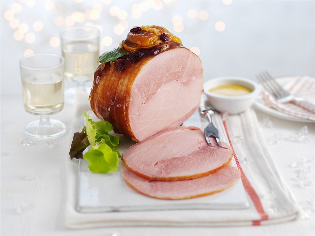 Glazed ham with dried apricots, sliced, for Christmas