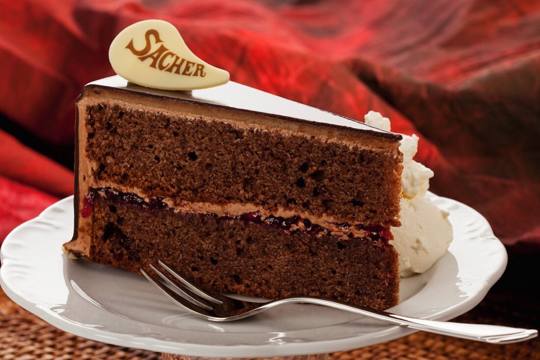 A slice of Sachertorte (rich Austrian chocolate cake)with cream